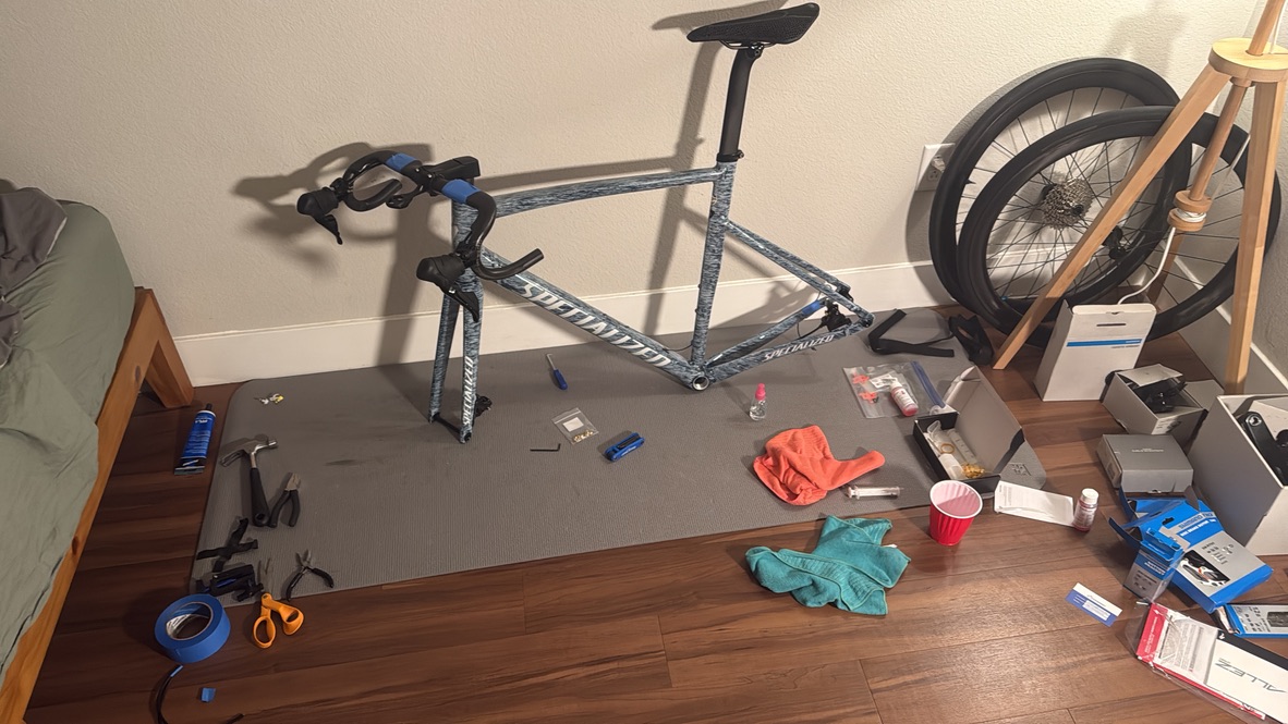 Picture of the unbuilt bike with lots of tools and disassembled parts together.